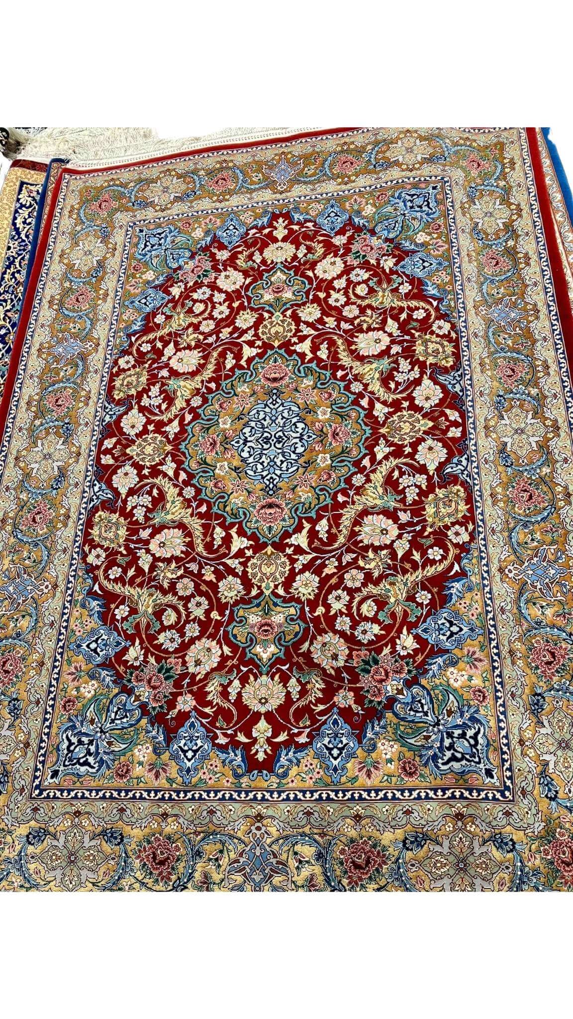 Persian rug featuring gold and red floral patterns, hand-knotted in Isfahan